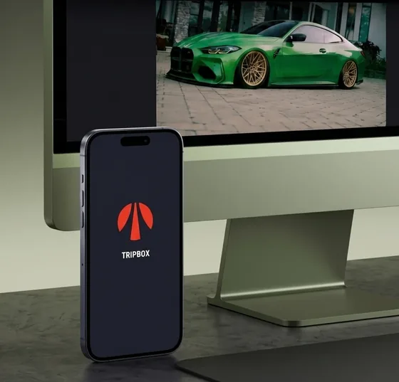 TripBox app on a phone and the website with a green car